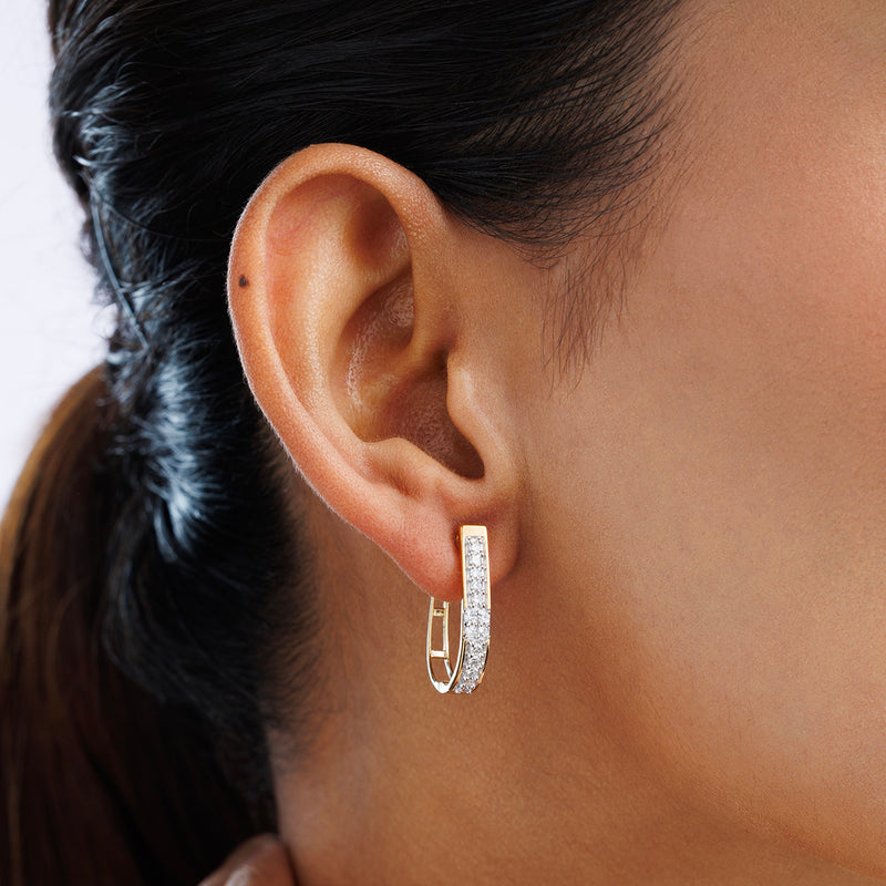 Close-up of a woman's ear wearing Keemti Jewels TRUE Spark Hoop Earrings encrusted with small diamonds.