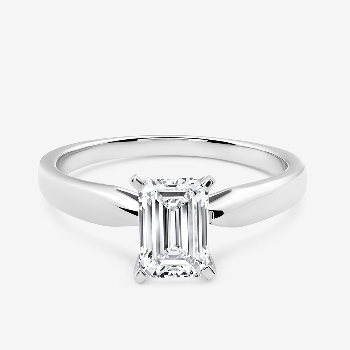 The Keemti Jewels MINIMAL <span>Emerald Solitaire</span> RING features a classic solitaire prong-set emerald-cut stone.