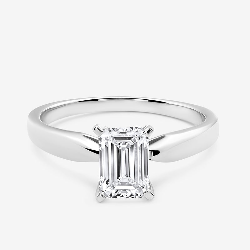 The Keemti Jewels MINIMAL <span>Emerald Solitaire</span> RING features a classic solitaire prong-set emerald-cut stone.