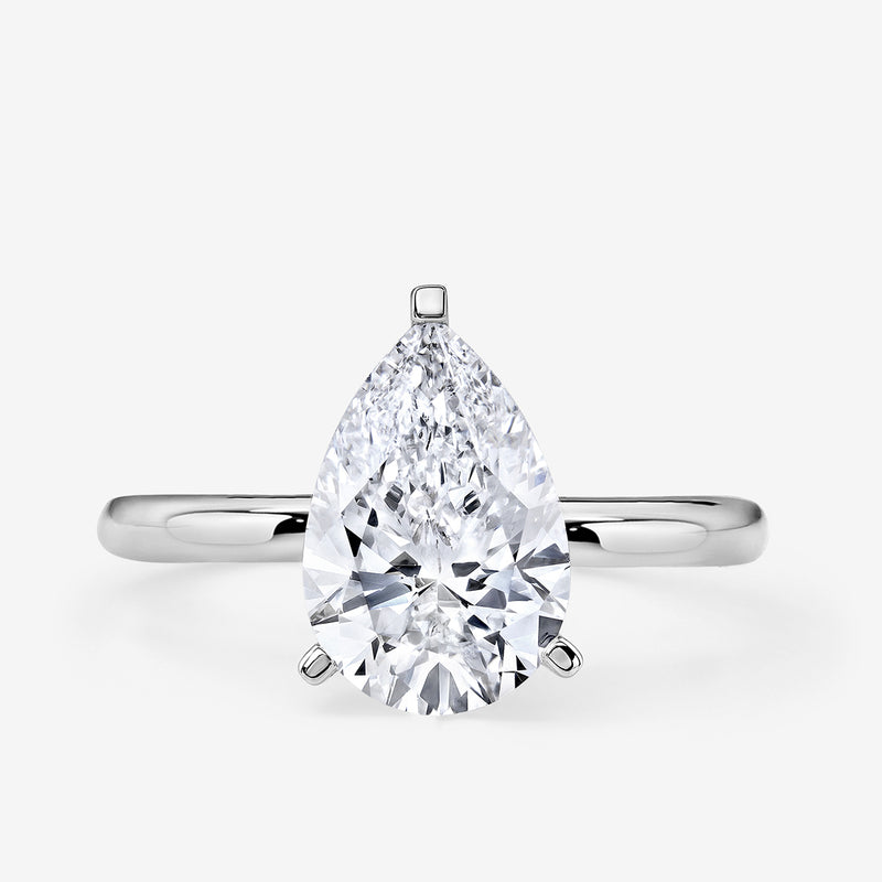 The Keemti Jewels EVERDEW Pear Solitaire Ring features a large pear-cut diamond on a simple silver band.