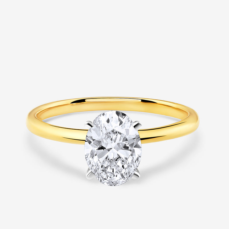 The MINIMAL Oval Solitaire RING by Keemti Jewels features a gold band and an oval diamond in a four-prong setting.