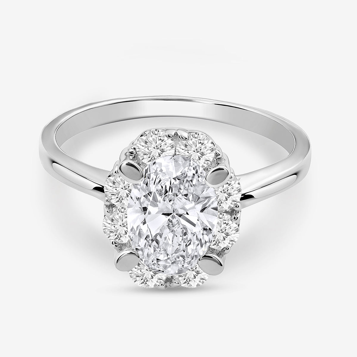 The CLASSIC Oval Mount Halo RING by Keemti Jewels features sparkling diamonds on a polished silver band.