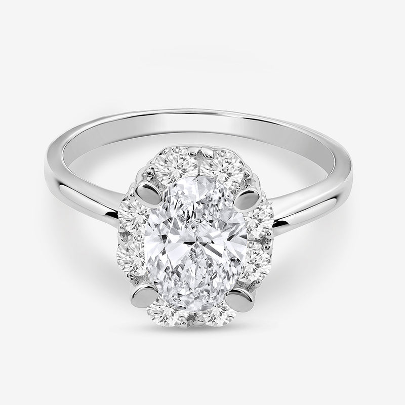 The CLASSIC Oval Mount Halo RING by Keemti Jewels features sparkling diamonds on a polished silver band.