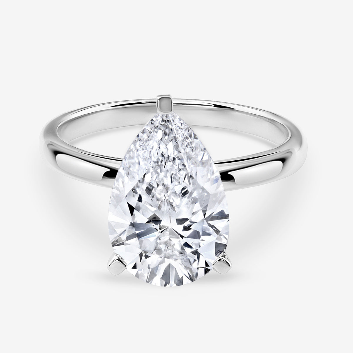 The TIMELESS Pear Solitaire RING by Keemti Jewels features a polished white gold or platinum band.