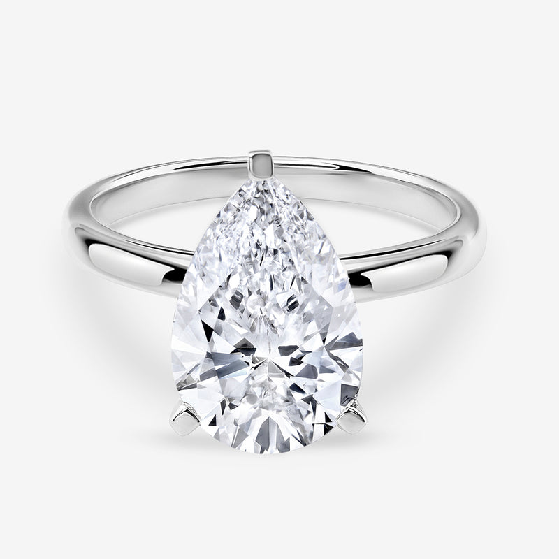 The TIMELESS Pear Solitaire RING by Keemti Jewels features a polished white gold or platinum band.