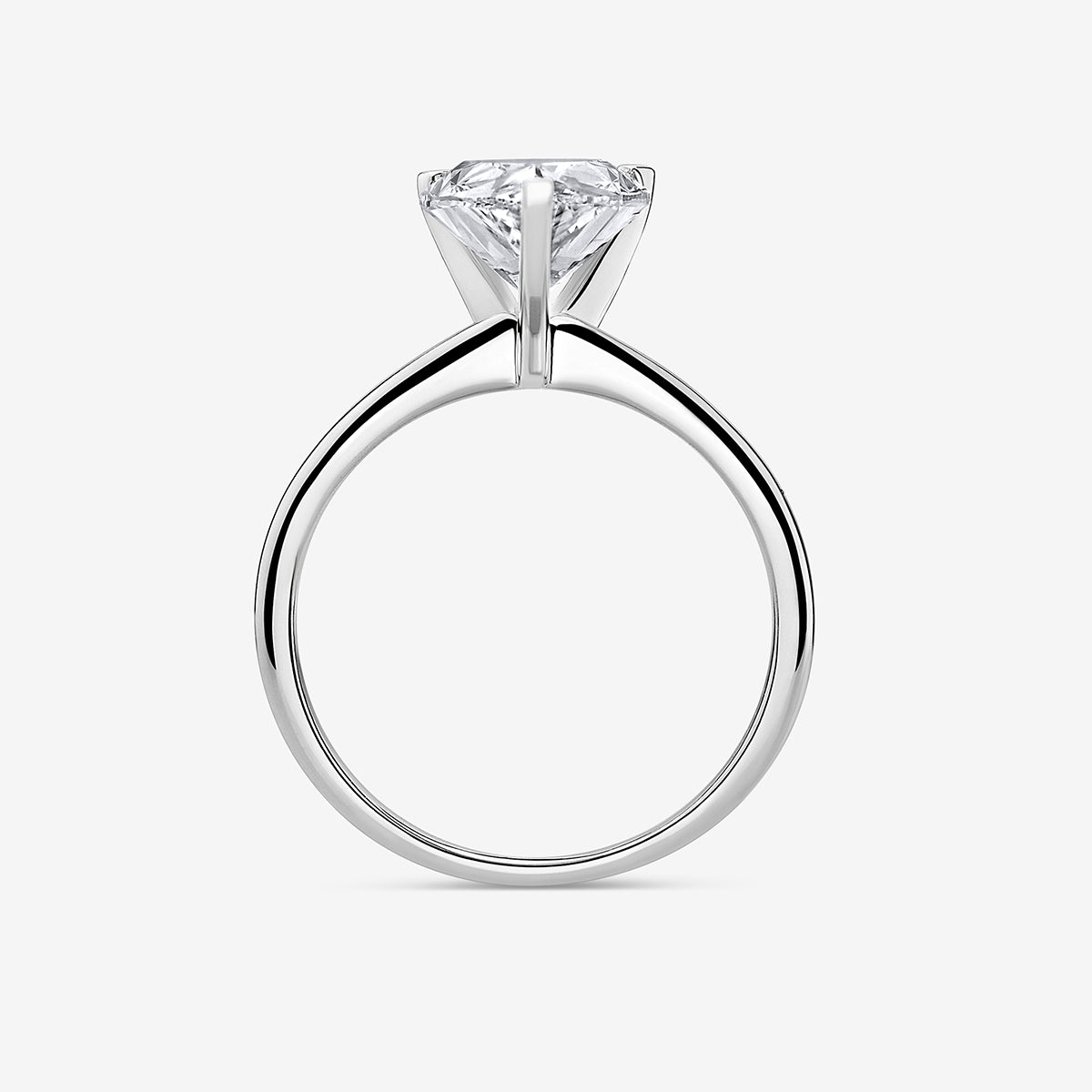 The TIMELESS Pear Solitaire RING by Keemti Jewels features a pear-cut on a sleek white gold band, shown from the side.