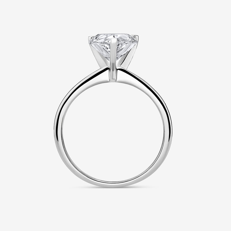 The TIMELESS Pear Solitaire RING by Keemti Jewels features a pear-cut on a sleek white gold band, shown from the side.