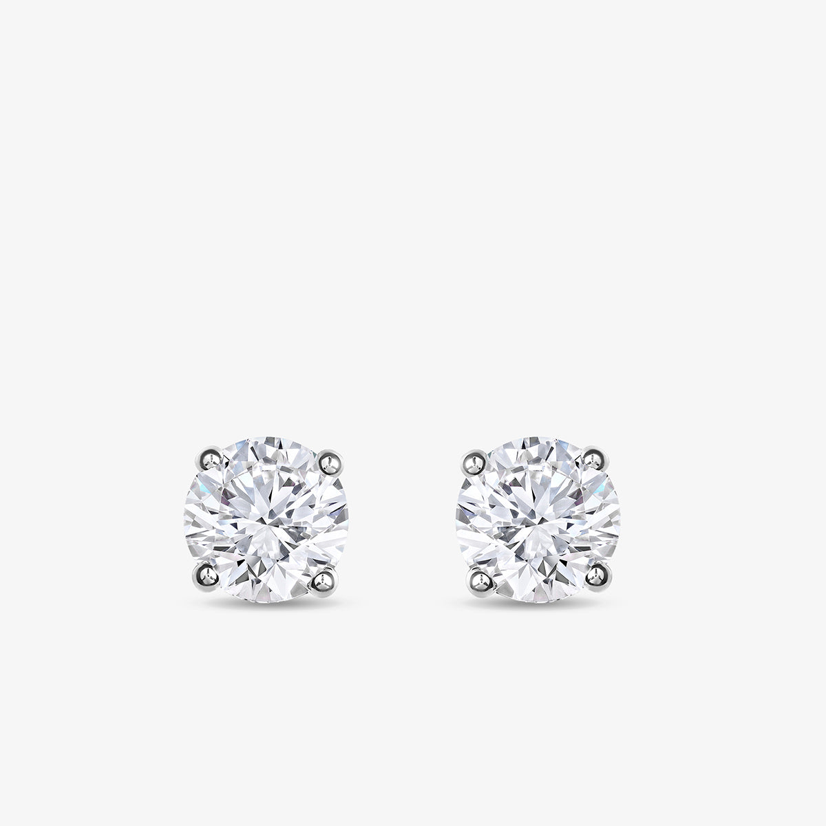 Keemti Jewels TIMELESS Solitaire Stud Earrings feature sparkling stones in four-prong white metal settings.