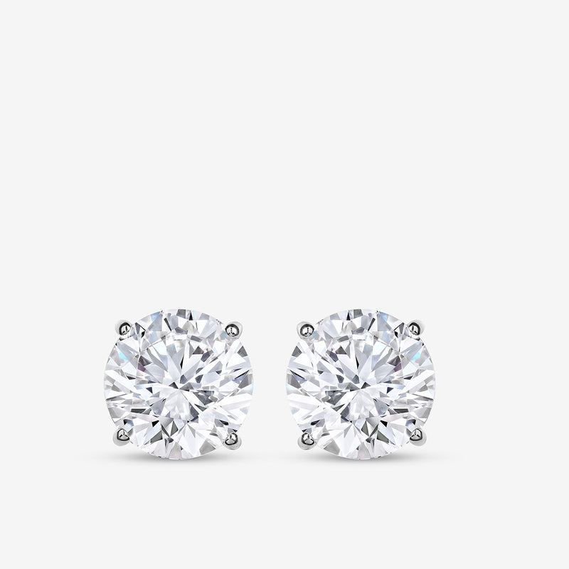 Keemti Jewels TIMELESS Solitaire Stud Earrings feature sparkling stones in four-prong settings on a white background.