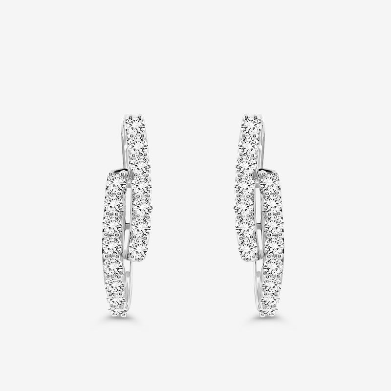 The SOLACE Arc Huggie Earrings by Keemti Jewels are silver hoops with two overlapping rows of sparkling white stones—an essential everyday jewelry piece, shown against a plain white background.