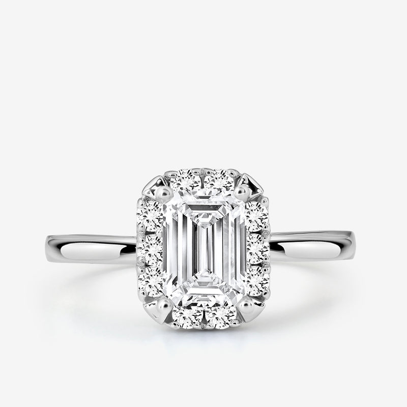 The EMERA Halo Solitaire Ring by Keemti Jewels features an emerald-cut in white gold with pavé and halo diamonds.