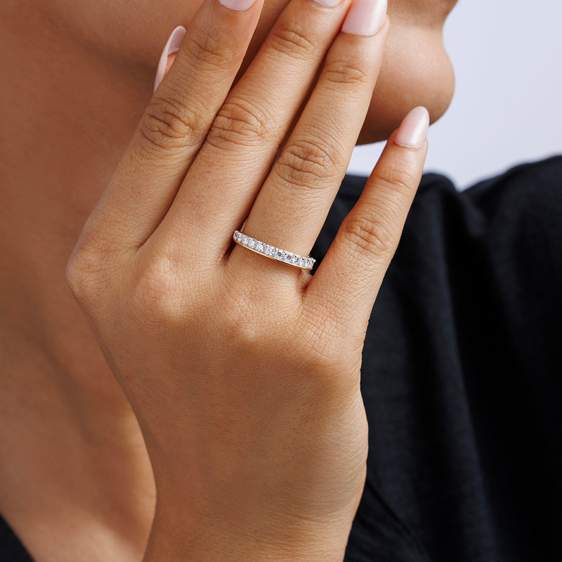 Half Eternity ring on finger, white round pavé stones on slim silver vermeil band