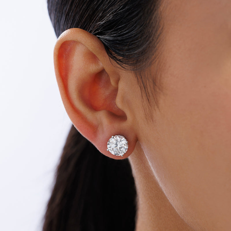 Close-up of a woman's ear wearing Keemti Jewels TIMELESS Solitaire Stud Earrings in a classic four-prong setting.