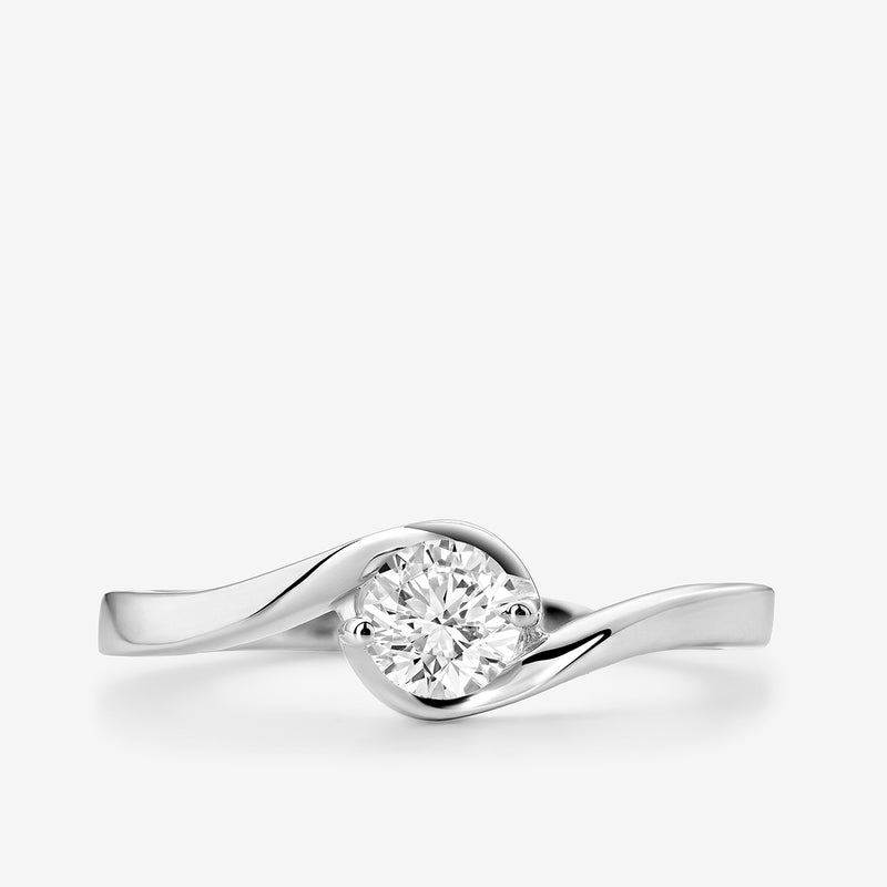 The RADIANT Swirl RING by Keemti Jewels features a round diamond on white gold with a modern, delicate design.