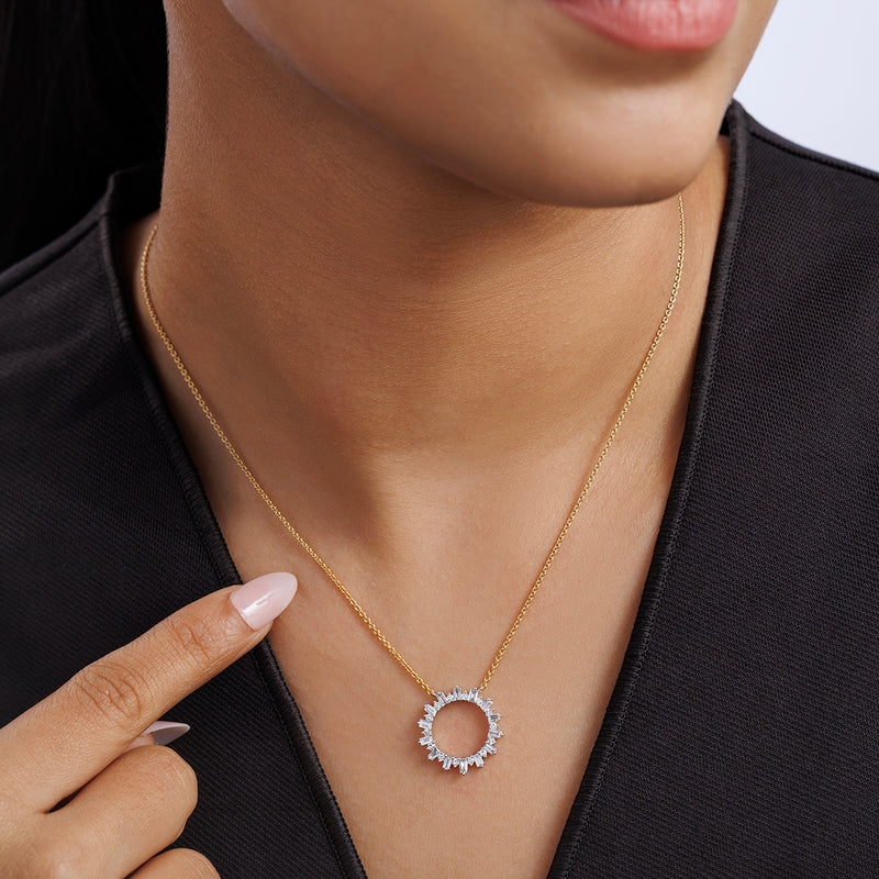 A woman in a black top points to her Keemti Jewels SPARKLING Circle Diamond NECKLET with sunburst pendant.