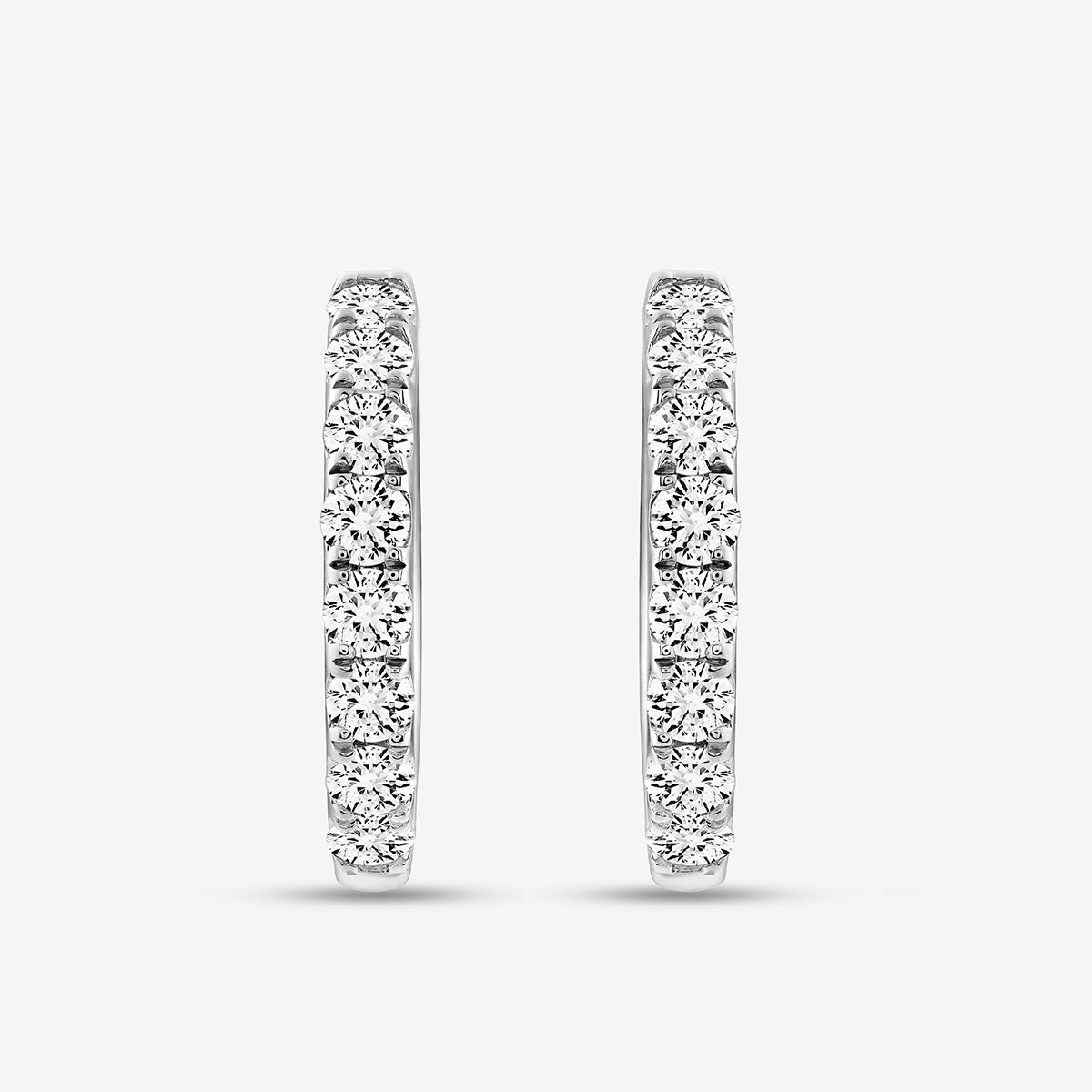 Keemti Jewels EDGE Glow Hoop Earrings: polished metal hoops with channel-set diamonds on a white background.