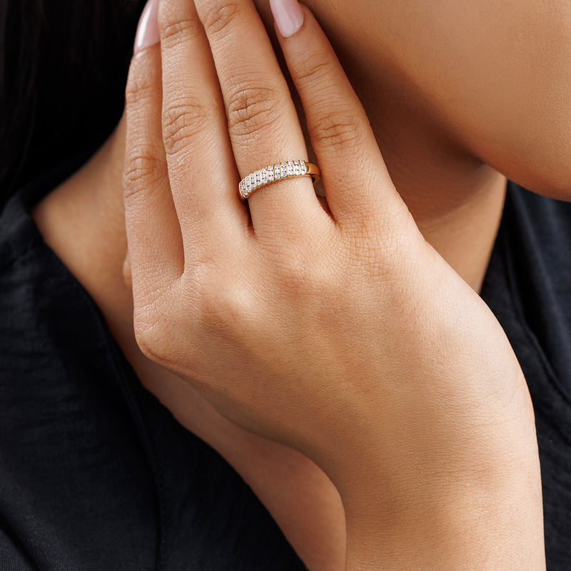 Groove band ring on finger with small white stones forming a continuous band