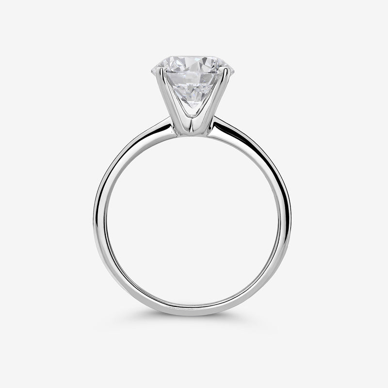 The ELEGANT Round Solitaire RING by Keemti Jewels features a round stone in a six-prong setting on a simple silver band.