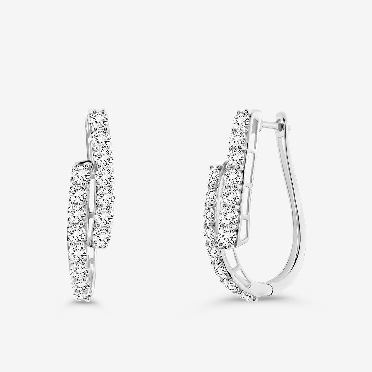 The SOLACE Arc Huggie EARRINGS by Keemti Jewels feature elegant curved hoops with two rows of sparkling white gemstones, displayed on a plain white background—an ideal choice for everyday essential jewelry.