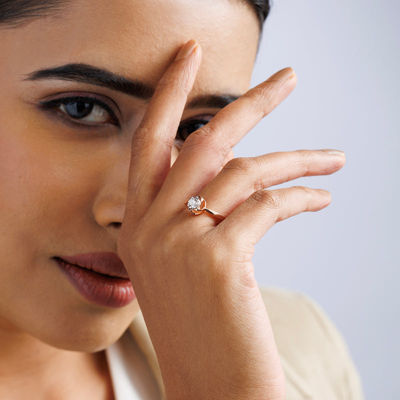 A woman with poetic charm models Keemti Jewels’ PROMISE Halo Solitaire RING, center diamond gleaming.