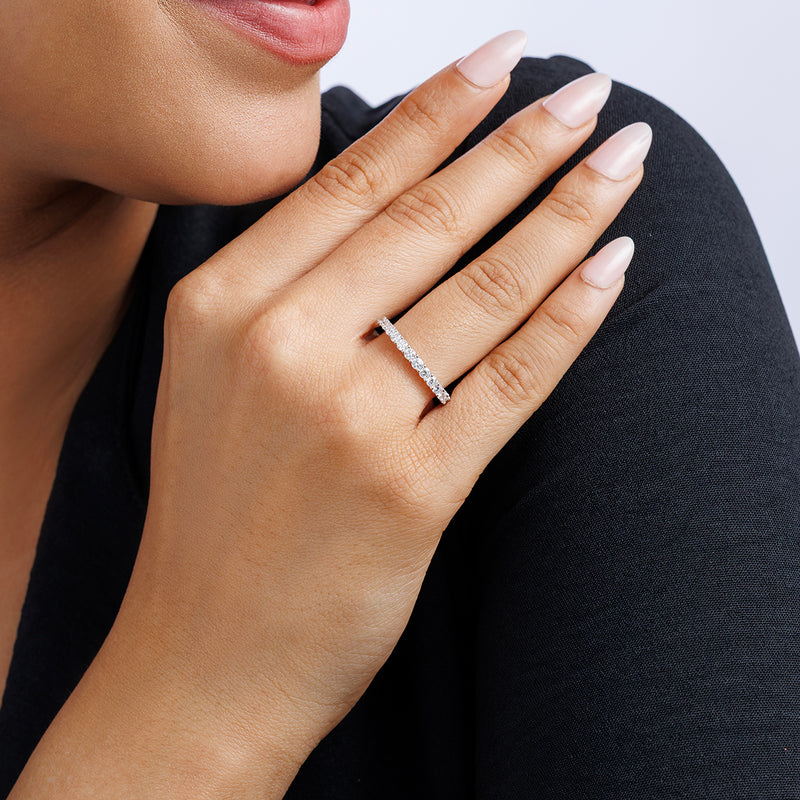 Rise Eternity ring worn on hand, slim band with pavé round stones