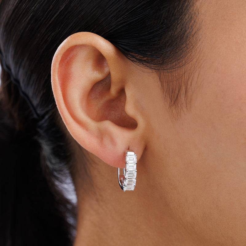 Close-up of a woman’s ear wearing Keemti Jewels ELYSIAN Hoop Earrings with channel-set clear gemstones.