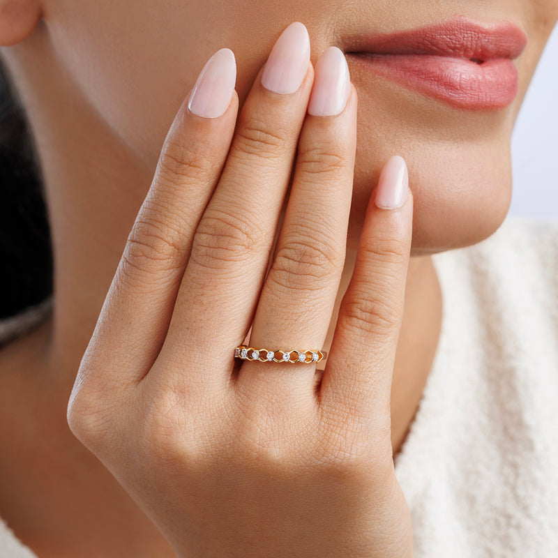 A woman with manicured nails touches her face, showcasing Keemti Jewels’ CREST Twist Diamond RING’s timeless elegance.