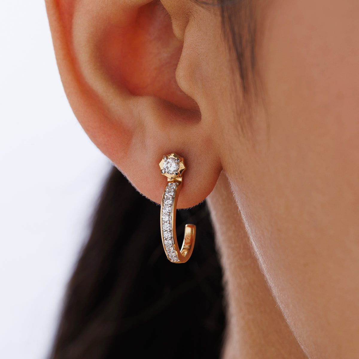 Close-up of an ear wearing Keemti Jewels AURA Dew Ear JACKETS: a gold hoop, two-tone sparkle, and a star stud.