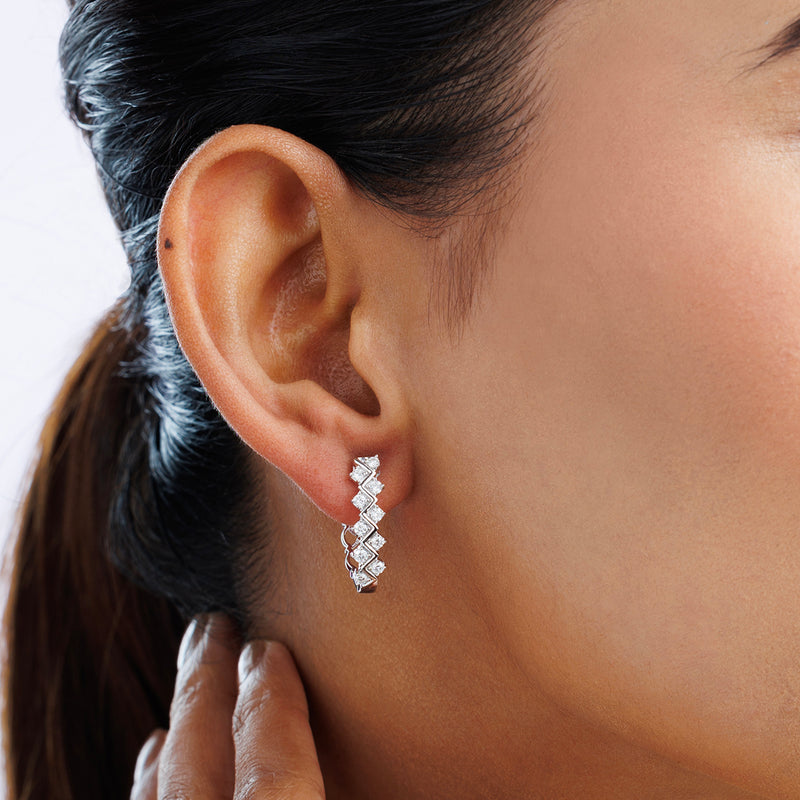 Close-up of a woman's ear wearing Keemti Jewels ENTWINED Spark Hoop Earrings, her hand gently on her neck.