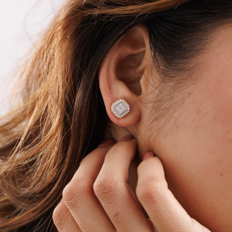 Diamond stud earrings in square halo setting on ear, gold-tone posts