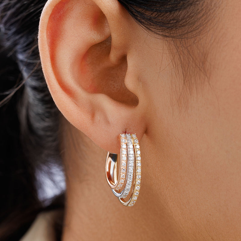 Close-up of a woman wearing Keemti Jewels TRIPLE Cascade Hoop Earrings with sparkling stones.