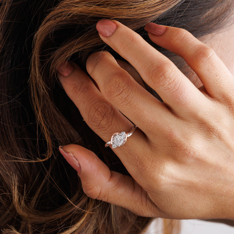 Two-tone ring on hand: silver band with roségold center and oval pavé setting