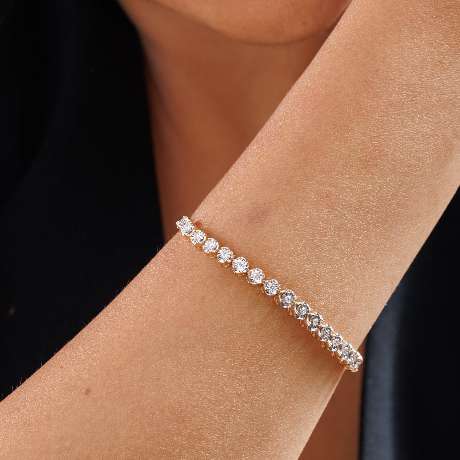 Keemti Jewels bolo bracelet on wrist, gold bezel row of round stones on silver chain