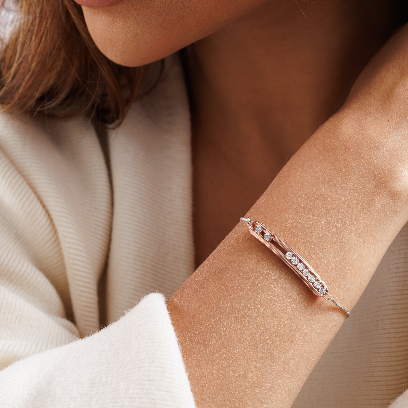 Spark Bolo bracelet on wrist: rose-gold bar with round stones on silver chain