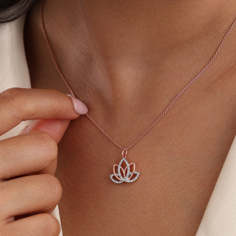 Rose-gold lotus pendant on a delicate chain, resting on the neckline