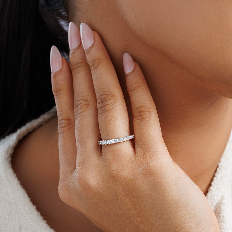 Finger wearing Classic Brightline ring with slim silver-tone row of round stones