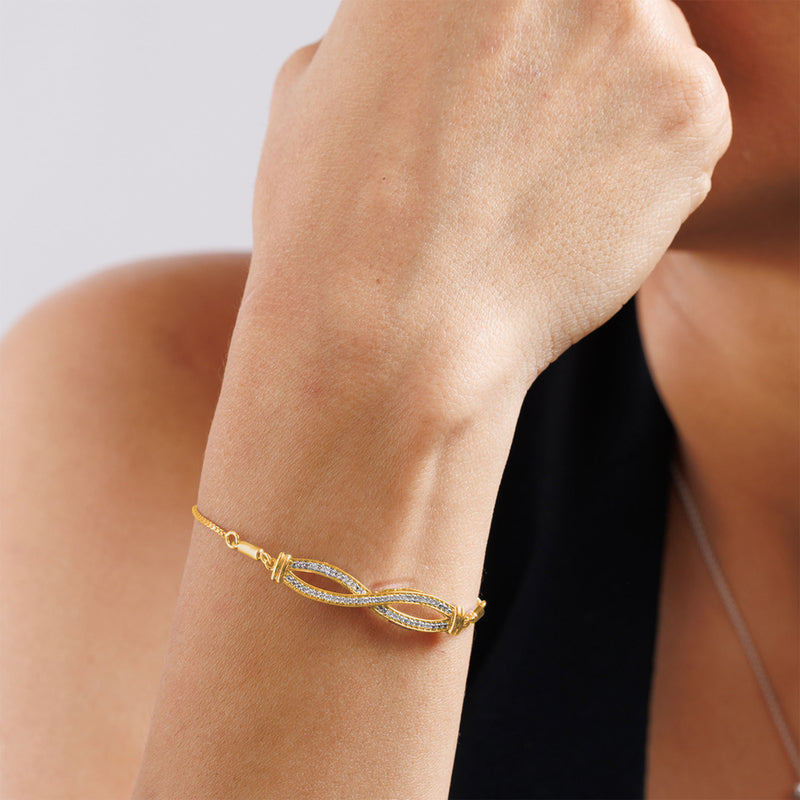 Keemti Jewels Infinity Diamond Bolo Bracelet with gold design, displayed on wrist against a plain background.