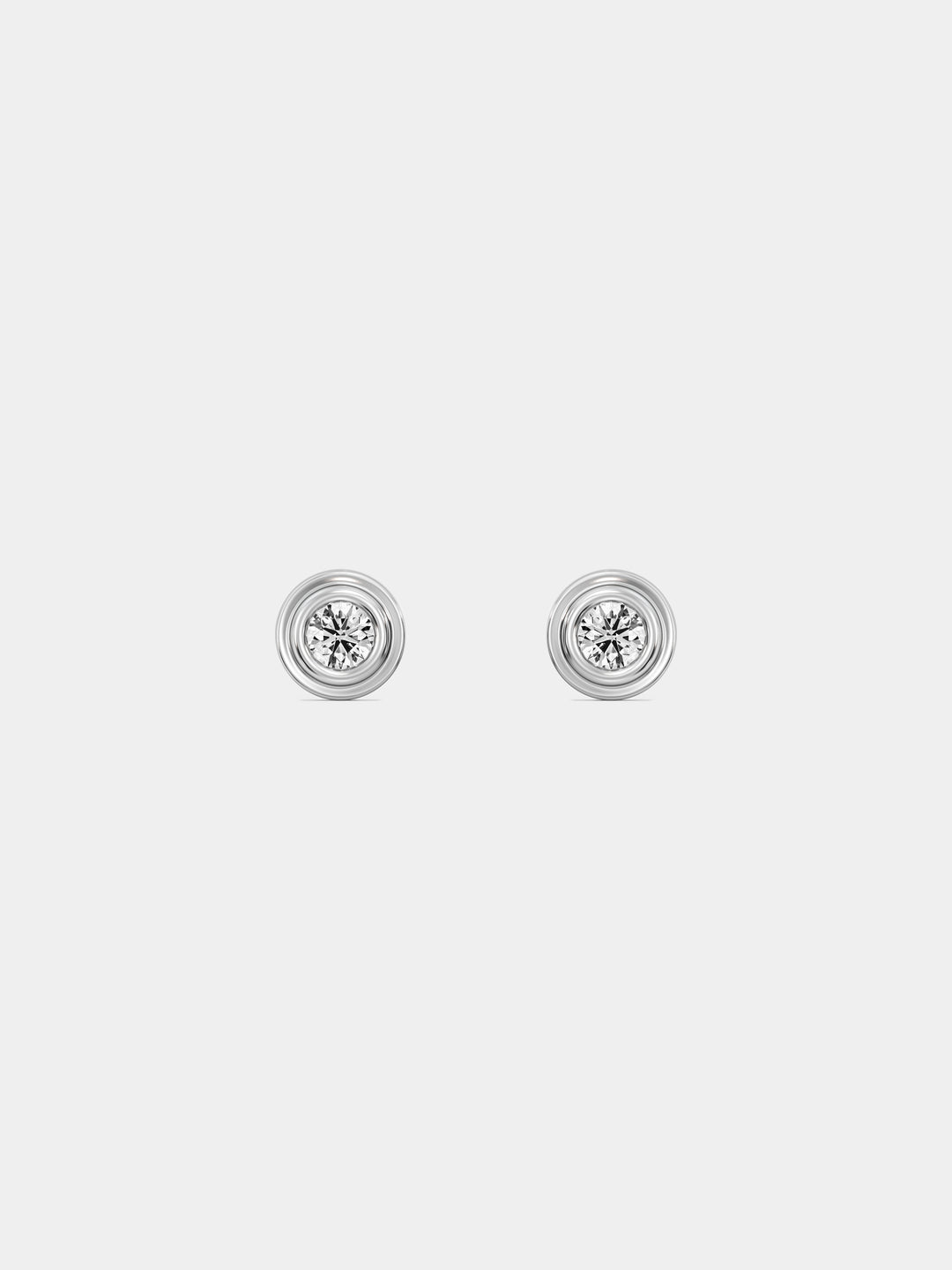 Classic round stud earrings with gold-tone bezel and white sparkling center stone