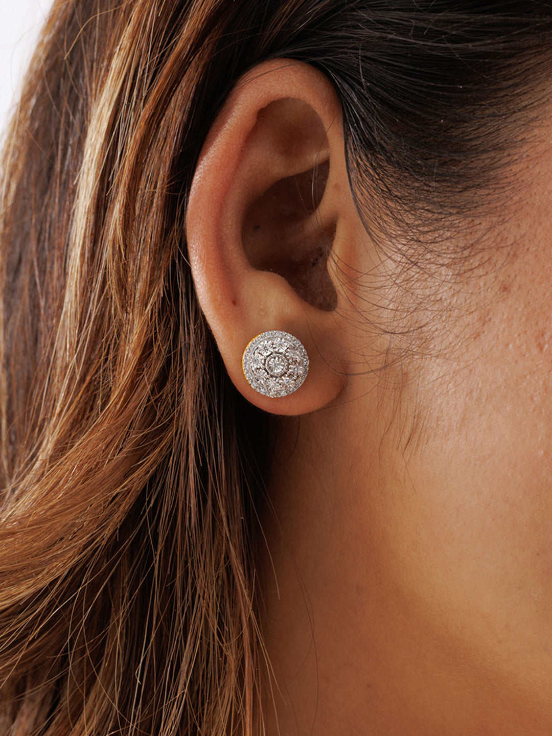 Close-up of a woman’s ear in brown hair wearing Keemti Jewels' Halo Bloom Stud Earrings: radiant silver diamond studs.
