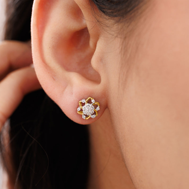 Close-up of an ear with Keemti Jewels' Floral Essence Stud Earrings—gold and diamonds for a feminine touch.