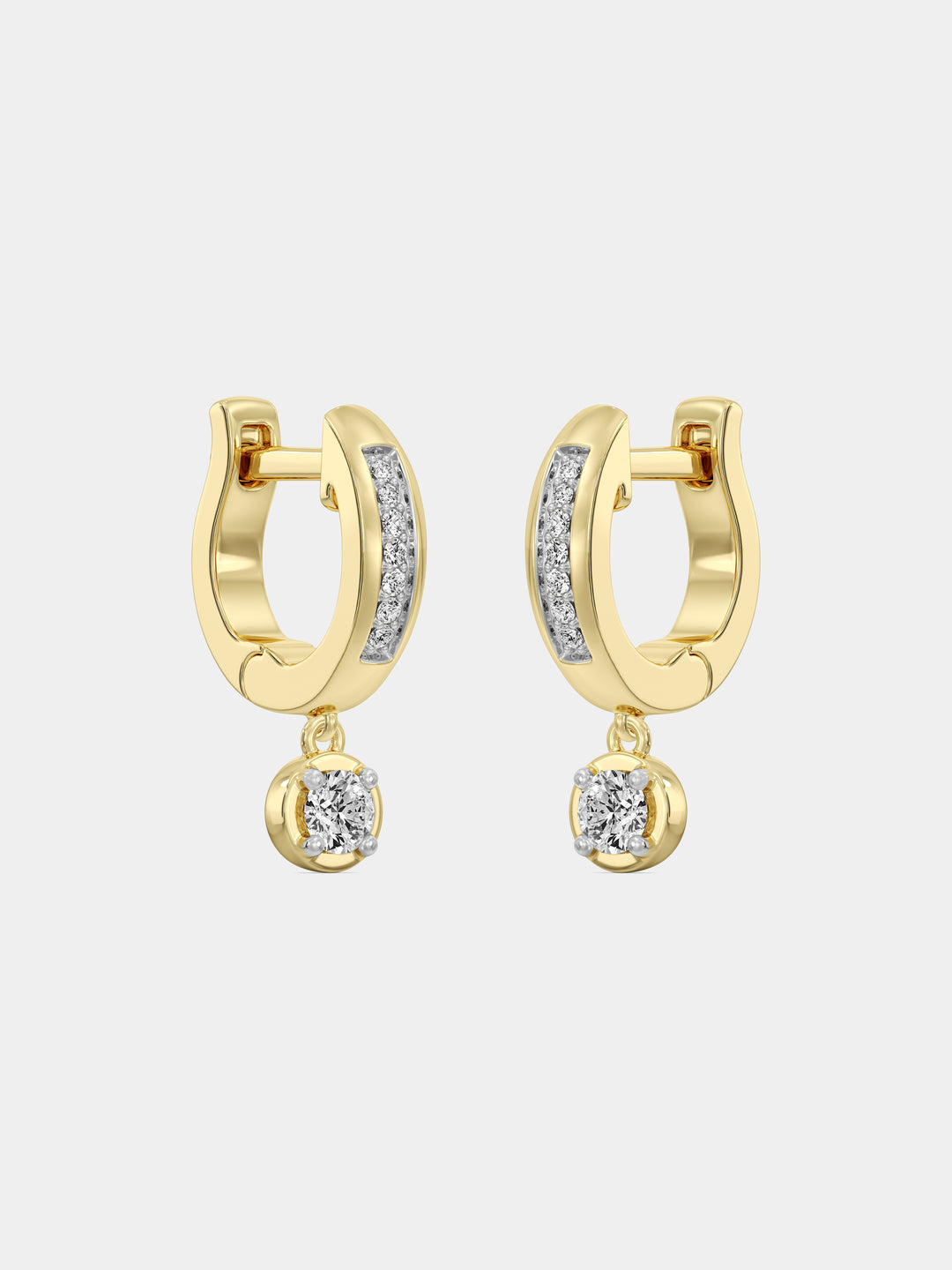 Close-up of a woman's ear wearing Keemti Jewels Mini Hoop Drop Earrings with a dangling clear gemstone.