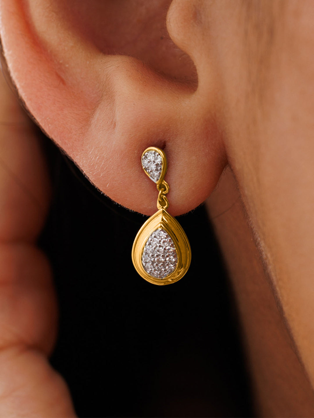 Close-up of a hand near the face, highlighting Keemti Jewels’ Classic Teardrop Statement Earrings for an elegant touch.