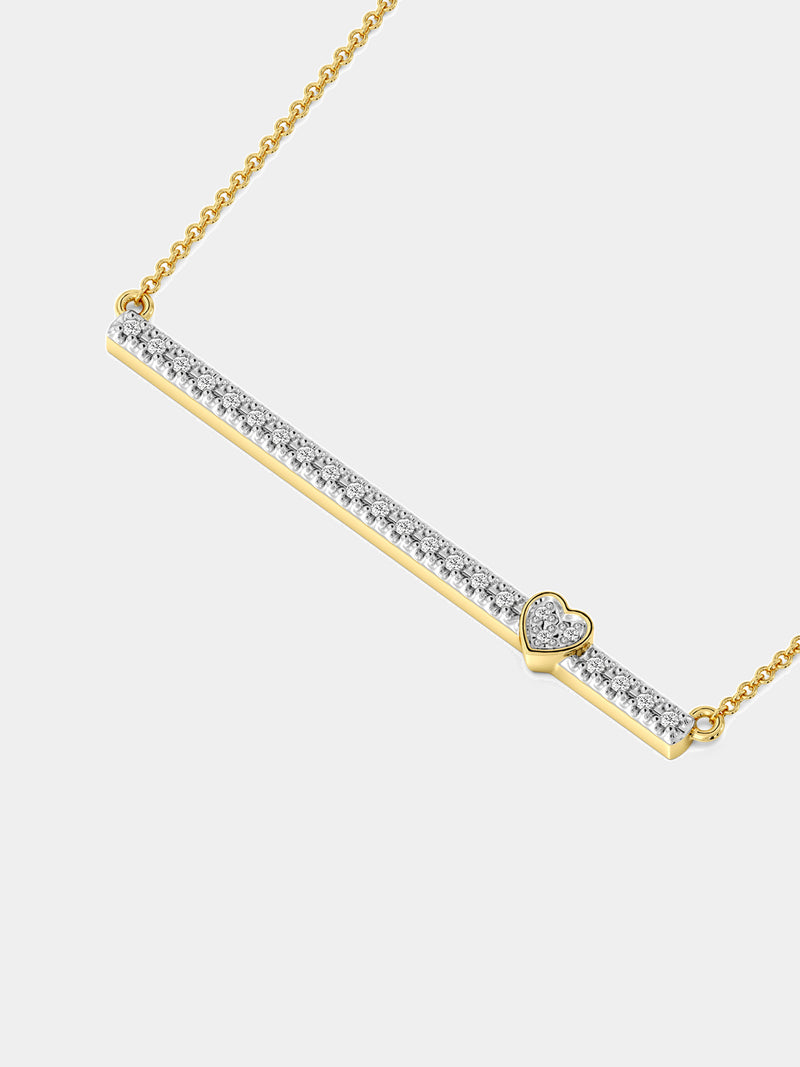 A woman wears Keemti Jewels' Linear Love Necklet with a horizontal diamond bar, paired with a dark top.