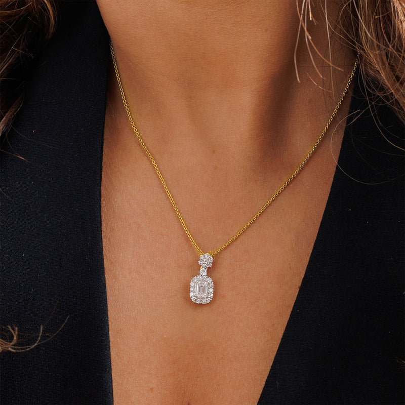 Eternal Emerald Halo Necklet by Keemti Jewels: an emerald-cut diamond pendant on gold, worn over a black top.