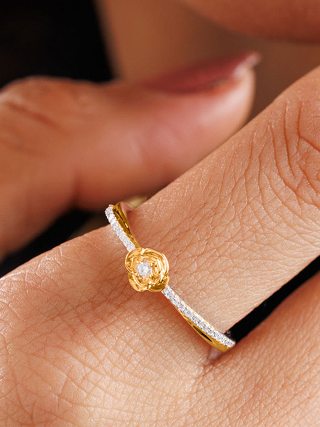 A person touches their lips, wearing Keemti Jewels' Petal Blush Promise Ring featuring a yellow gemstone.