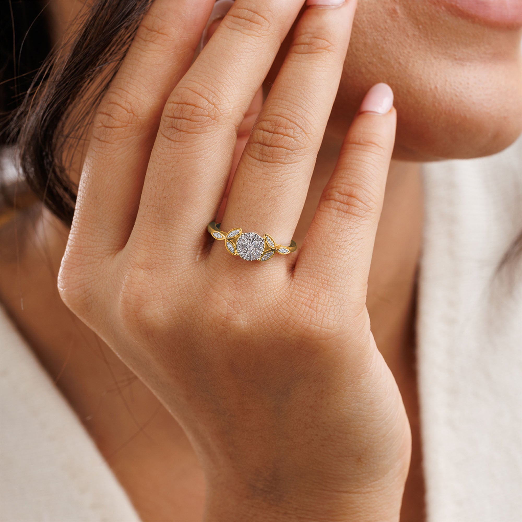 A woman’s hand in the Iris Sparkle Cluster Ring by Keemti Jewels—vintage gold with dazzling diamonds near her face.