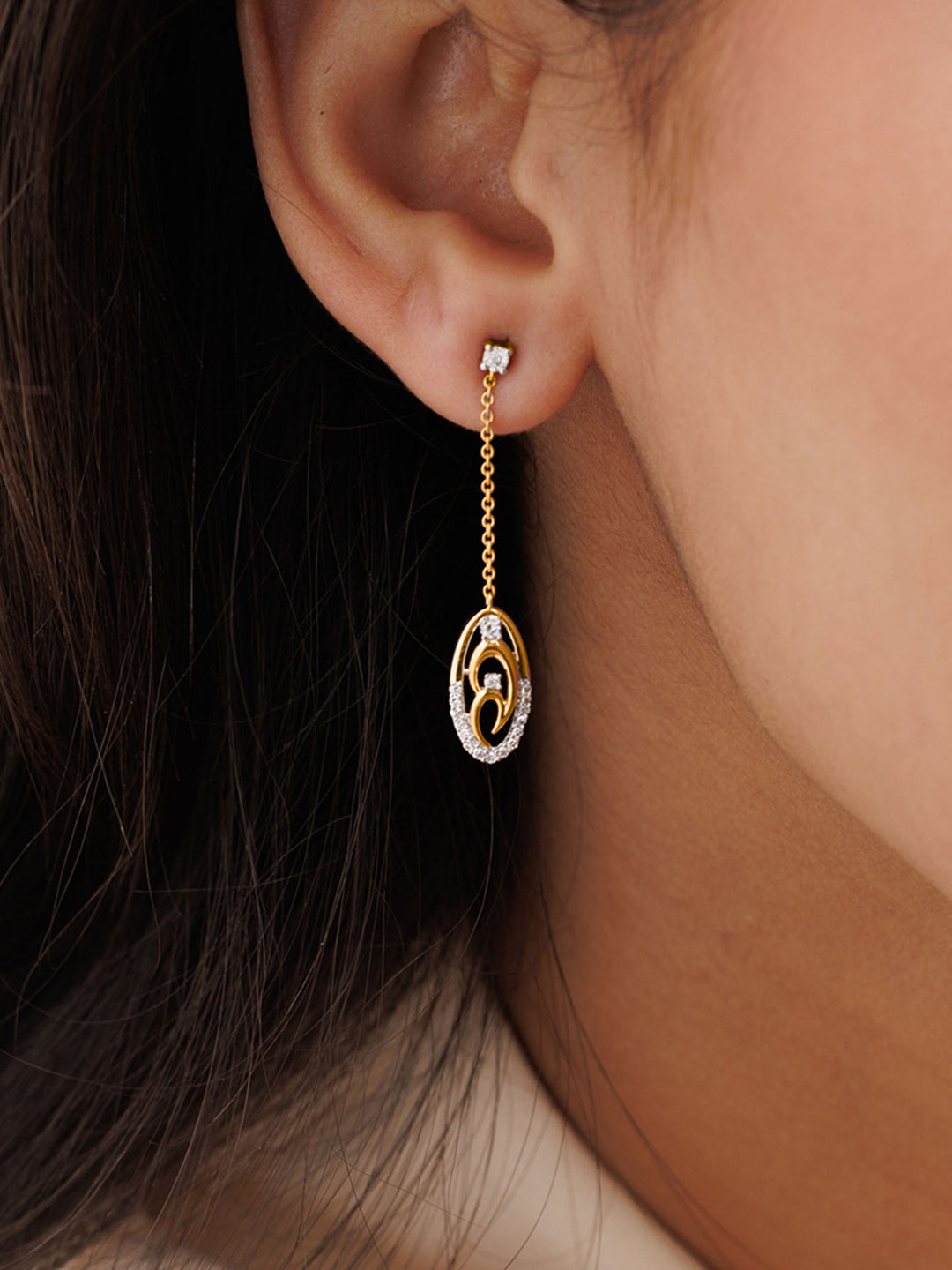 Close-up of a woman's ear wearing Keemti Jewels' Two-Tone Chain Drop Earrings in a minimalist, circular design.
