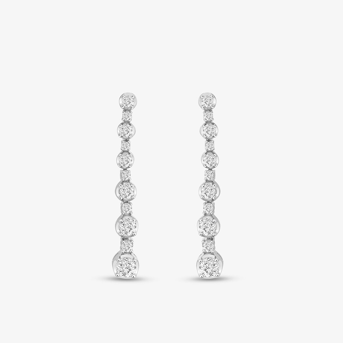 A woman’s ear adorned with Keemti Jewels Linear Diamond Drop Earrings, featuring vertical round sparkling stones.