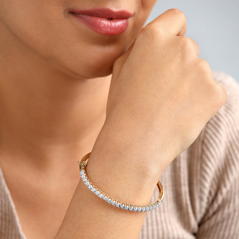 A woman in a beige top wears the Keemti Jewels Sparkle Line Diamond Bracelet, resting her chin on her hand.