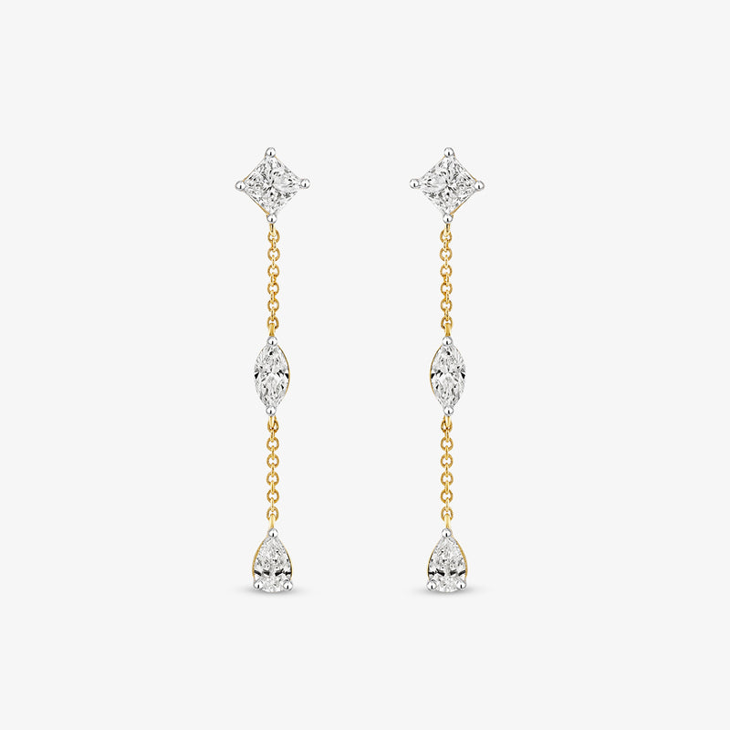 Keemti Jewels' Cascade Prism Diamond Drop Earrings feature three clear gems on a gold chain, set against a white backdrop.